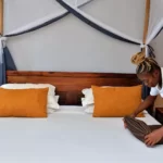 femme de chambre en train de décorer le lit